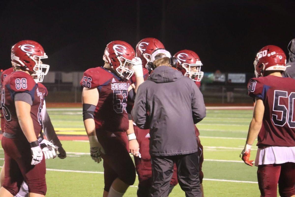 Junior Thomas Cromer and the rest of the offensive line huddle during a timeout in the game against Bishop Miege.