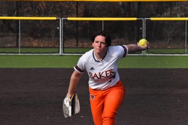 Photo courtesy of Baker Athletics. Kira Baker pitches during her perfect game for Baker University against Saint Mary-of-the-Woods on Feb. 19. It was just one aspect of her dominant start pitching at Baker where she has amassed a 5-0 record through six appearances and has not allowed an earned run.