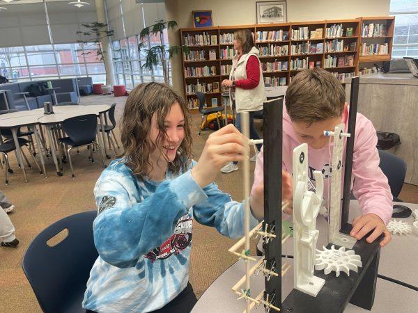 Freshmen Adria Chrislip and Jason Ditty build a project that triggers a signal occurring at equally spaced time intervals ahead of Science Olympiad’s state competition, where they will answer questions related to time and show their project in It’s About Time.