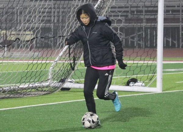 Xin Clobes dribbles the ball during a drill at a practice on March 9.
