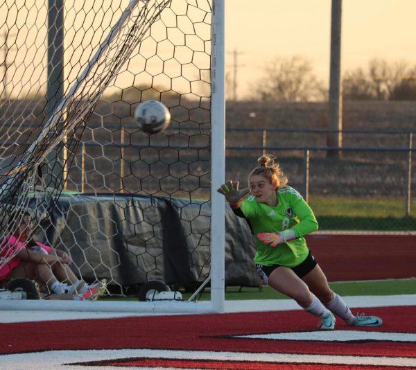 Senior goalkeeper Kambry Shockley dives for a save against an opposing shot on goal. Photo by Nathan Swaffar.
