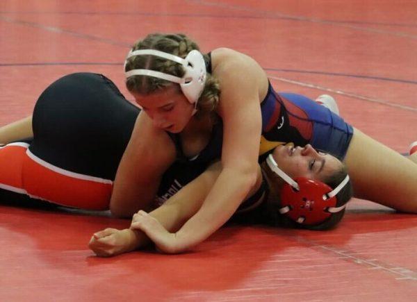 FILE PHOTO. Senior Madison Karten pins her opponent during the girls wrestling team’s mixer on Dec. 8.
