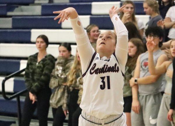 Senior Parker Long shoots a 3-pointer during the game against Atchison Thursday night. Long had 11 points and hit three 3s on the night.