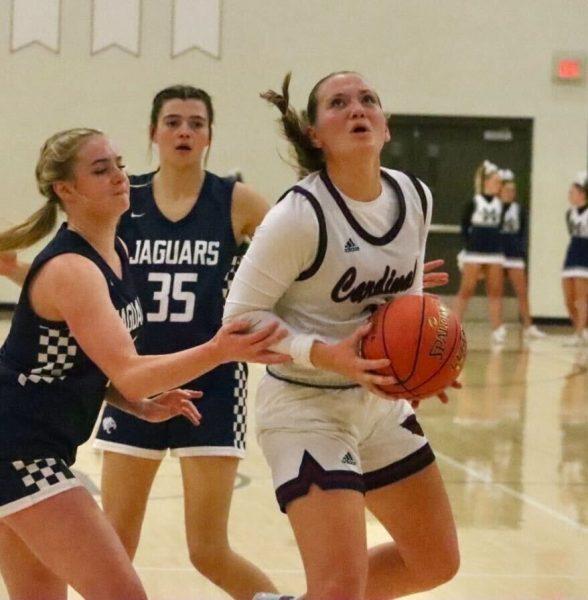 Senior Kenzie Yoder eyes the basket as she gathers the ball during the game against Mill Valley Tuesday night. Yoder had six points on the night.