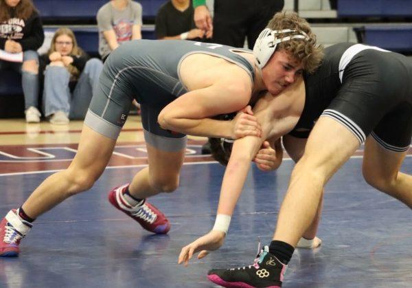 Freshman Newt Schreiner tries to get position on his Emporia opponent during the tournament of champions Saturday. Schreiner went 5-0 on the day.