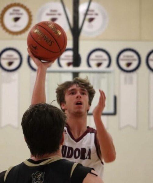 Junior Connor Watson raises above everyone to put up a shot against Paola Tuesday. Watson had 10 points against the Panthers. 
