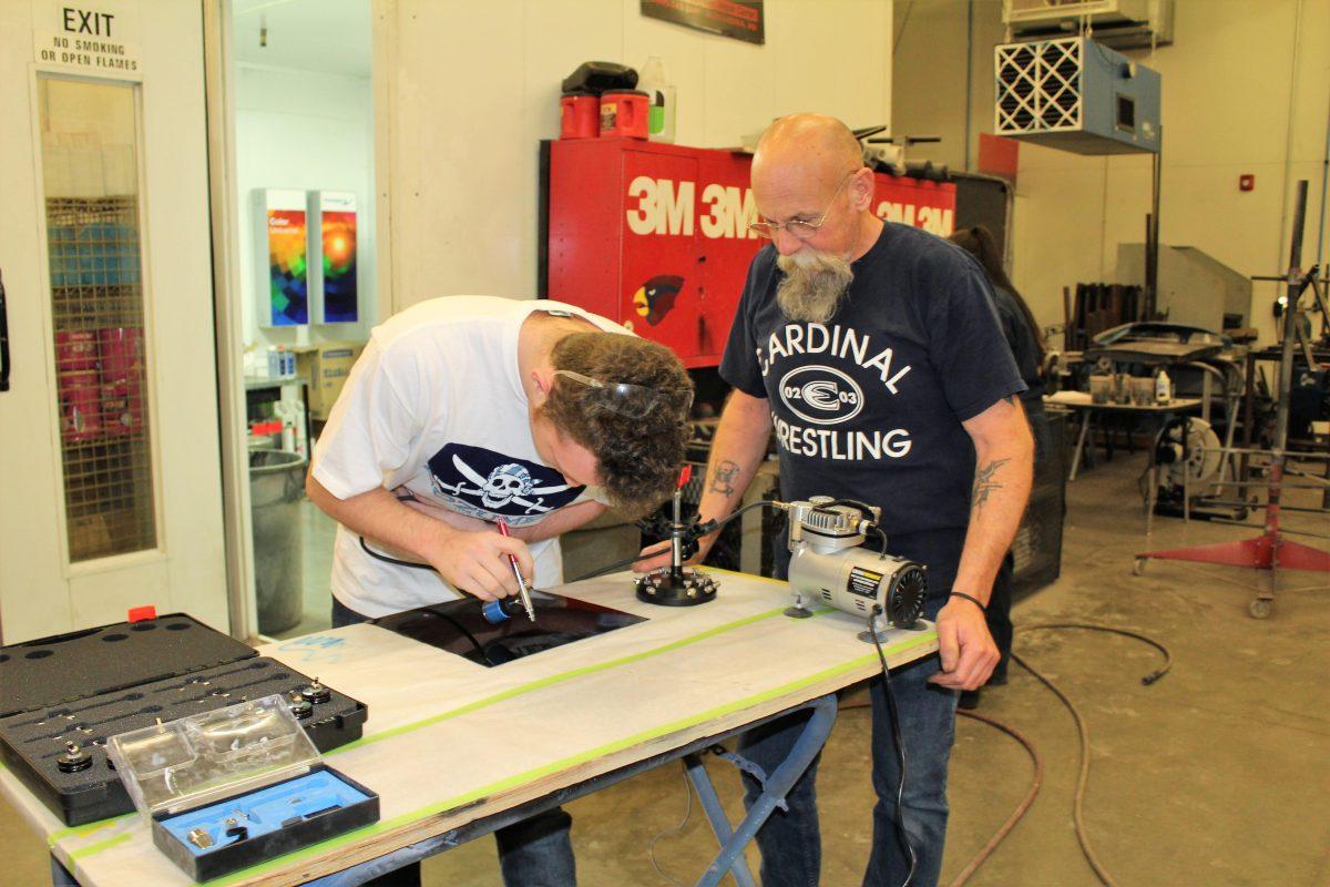 Submitted photo. Chris Paxton helps a student in the classroom.&#160;