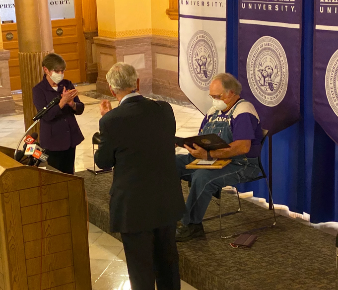The farmer who provided masks to Gov. Andrew Cuomo is presented with a degree from Kansas State University.