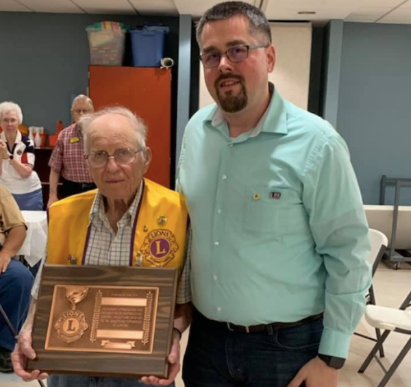 Bob Slapar is recognized for his 65th anniversary with The Eudora Lions Club by club president Eric Strimple and other members.