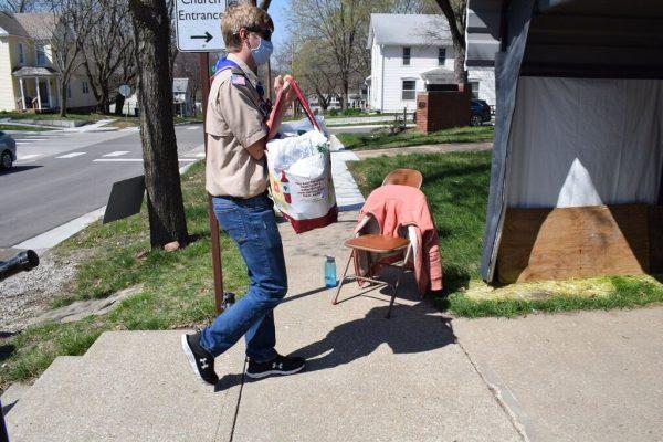 Steven Young brings a bag of food donations into the St. Paul Church of Christ during the 34th annual Scouting for Food event.