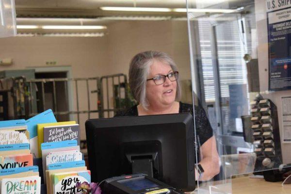 Michelle Gabriel greets a customer at the post office.