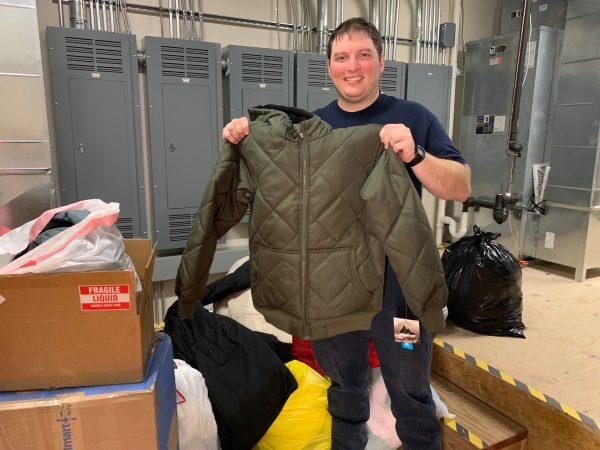 Chris Hull holds one of the coats recently donated to the drive at the fire station. Any coats in new or gently used condition can be donated to the drive.