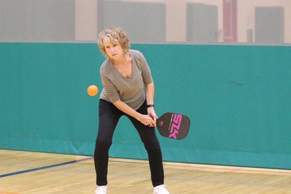 Sandy Morgan Cockrum prepares to hit the pickleball during the group’s evening session at the rec. Sandy and her husband David Cockrum have been playing with the group for three years.