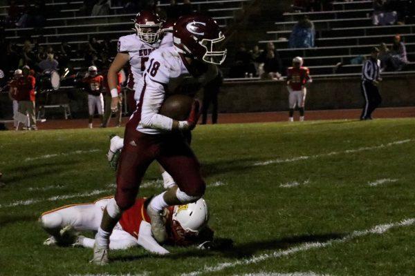 Freshman Errol Siemon rushes by an Atchison defender for a touchdown.
