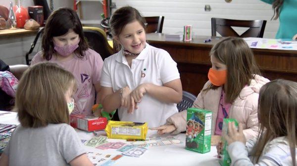 Troop #20951 Girl Scouts Miranda Horner, Hadley Lewis and Cora Lyons practice selling cookies during their meeting Tuesday.