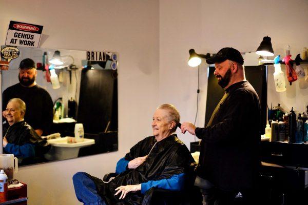 Brian Winslow chats with his friend and client Bunny Chilcoat while doing her hair for one of the last times before retirement. 