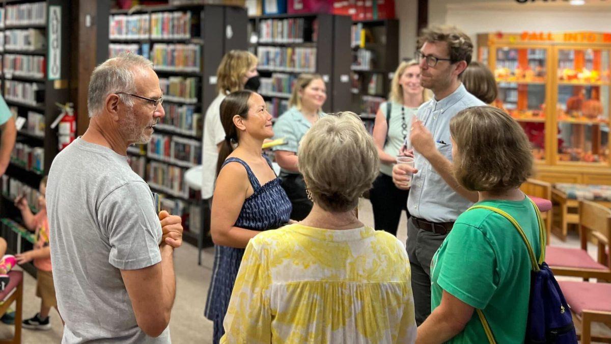 Community members visit with Eudora Times staffers at the library Monday evening.&#160;