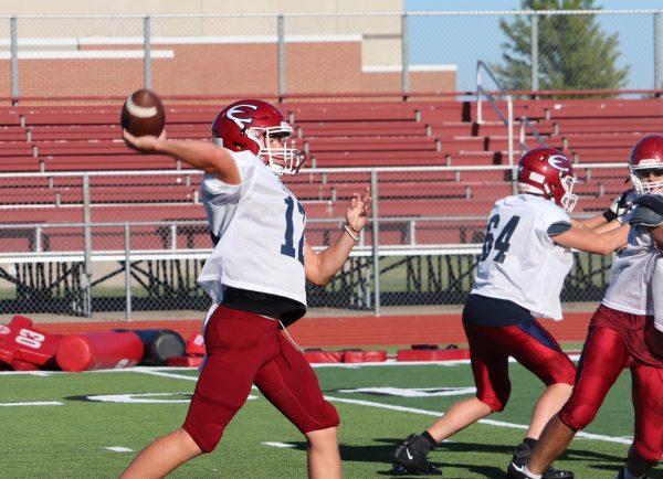 Junior quarterback Kole Manley throws a deep pass during the offensive team portion of practice.
