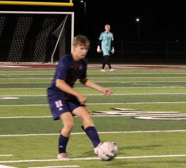 Junior Kaden Kerr dribbles the ball against Basehor-Linwood Monday night in an effort to tie the game for the Cardinals.