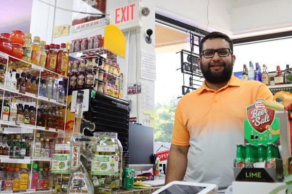 Hardeep Gosal stands behind the counter of Main Street Wine & Spirits.