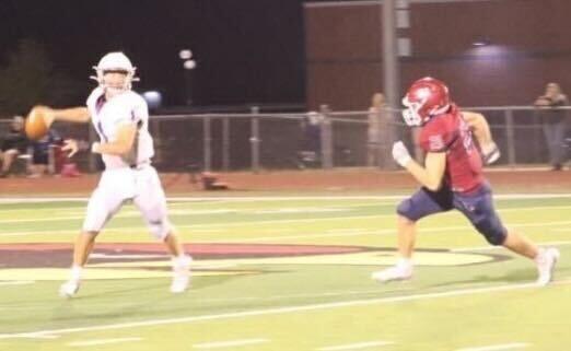 Freshman Braedon Speer chases down Louisburg&#8217;s quarterback after he scrambles out of the pocket. Speer made several tackles on defense against Louisburg.