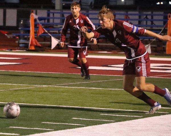 Senior Parker Hurla fires a shot at the goal Tuesday night against Topeka, in an effort to get his team back in the game with time running down.