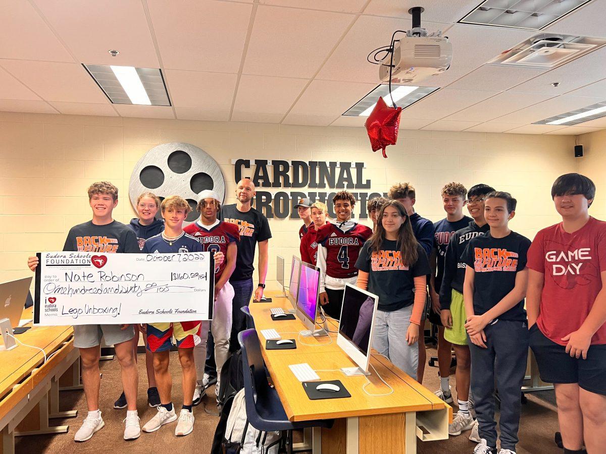 Nate Robinson poses with his production class after learning the Eudora Schools Foundation gave him a grant to buy Legos for a class project. Students will get to unbox Legos and create a stop motion video.