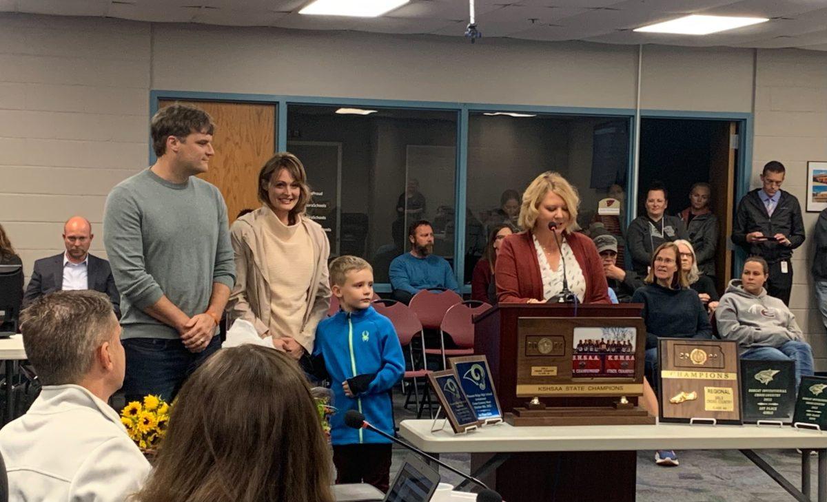 Board member Heather Whalen recognizes owner of Twill Trade Boutique Elizabeth Knispel and her family as the 2022 Outstanding Cardinal Partner during Thursday&#8217;s school board meeting.