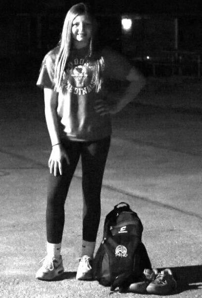Eudora youth sport athlete Braydee Miller stands by her equipment bag in downtown Eudora.