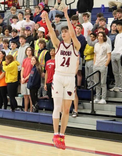Junior Logan Sullivan shoots a 3-pointer in front of the Eudora student section during the game against Paola Friday. Sullivan finished the game with 26 points.