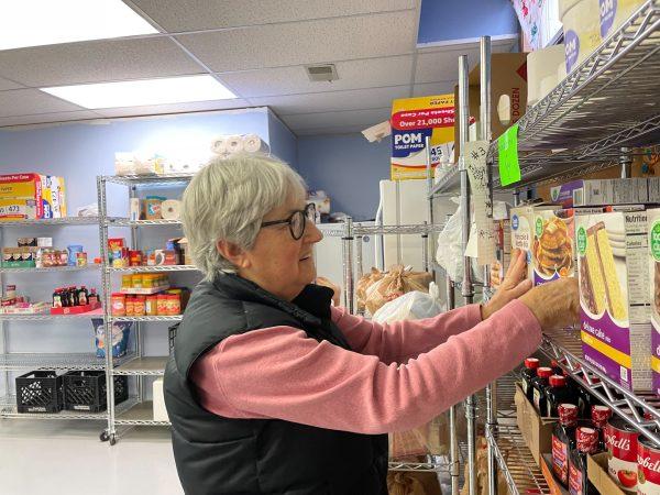 Marsha Gordon organizes and stocks shelves Wednesday morning at the Eudora Food Pantry at St. Paul United Church of Christ.