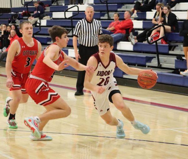Senior Conor Dunback drives the ball inside while being challenged by an Ottawa defender. Dunback said the Cardinals offense was successful Tuesday night because of how they were able to penetrate and kick the ball out to open shooters.