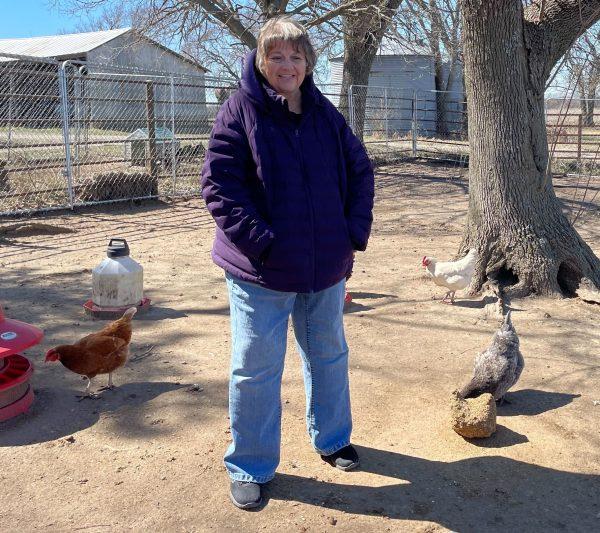Country Road Farms and Country Market co-owner Jamie Knabe poses alongside her flock. Her birds are raised naturally, meaning their eggs are organic.
