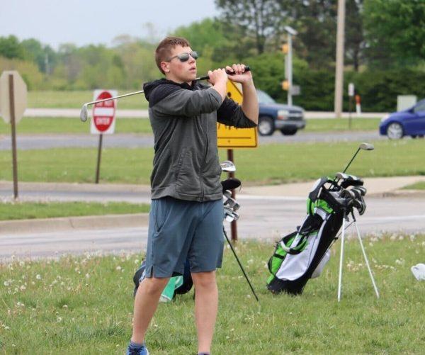 Junior Preston Bruce watches where his ball lands during practice Thursday night. Photo by Jack Denebeim.