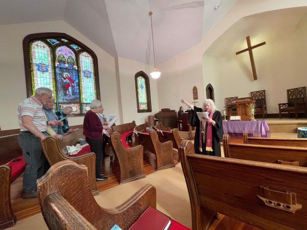 Congregants followed along as the Rev. Mauri Peaco led them through the Palm Sunday service at St. Paul Church of Christ.