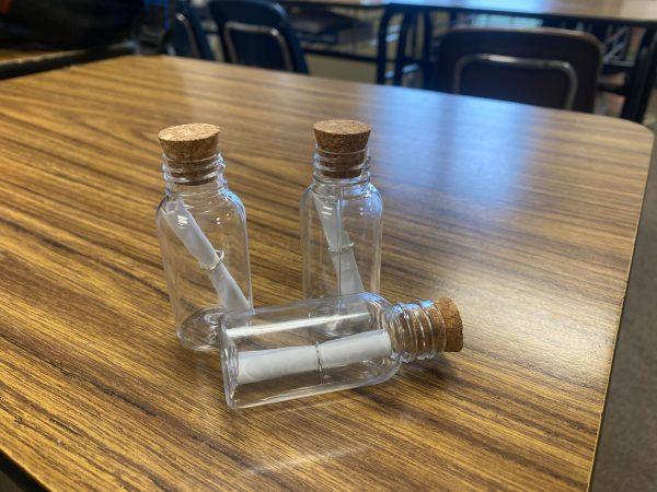 Be on the lookout: The small glass bottles have a cork top and the poems wrapped up inside of them.
