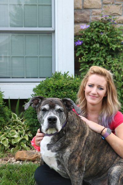 Eve Pierson, a decade-long resident of Eudora, sits with her dog, Brynn. Pierson helps the community locate lost dogs via Facebook groups and word of mouth.  