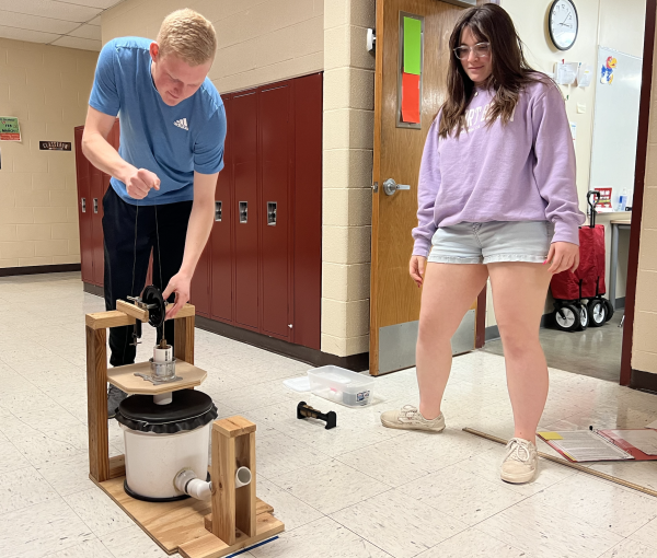 Ryleigh Hartwell and Nathan Steinlage work on their air trajectory project before regionals Saturday. 