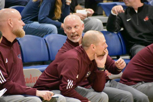Kyle Deterding leans forward and watches the girls basketball team in its home opener Tuesday. This is his first year as an official coach for his daughter, Brynn Deterding, but he’s been her basketball mentor for years.