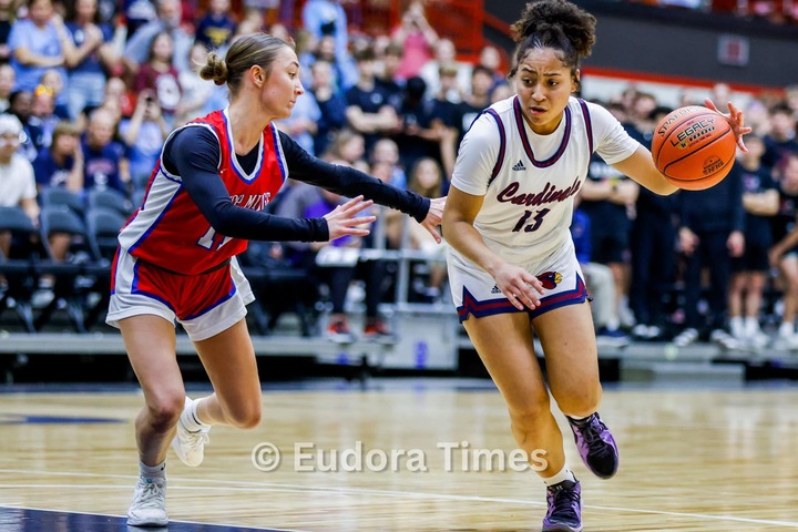 Freshman Avah Dye drives past a Bishop Miege defender during the state basketball quarterfinals Thursday night in Salina.
