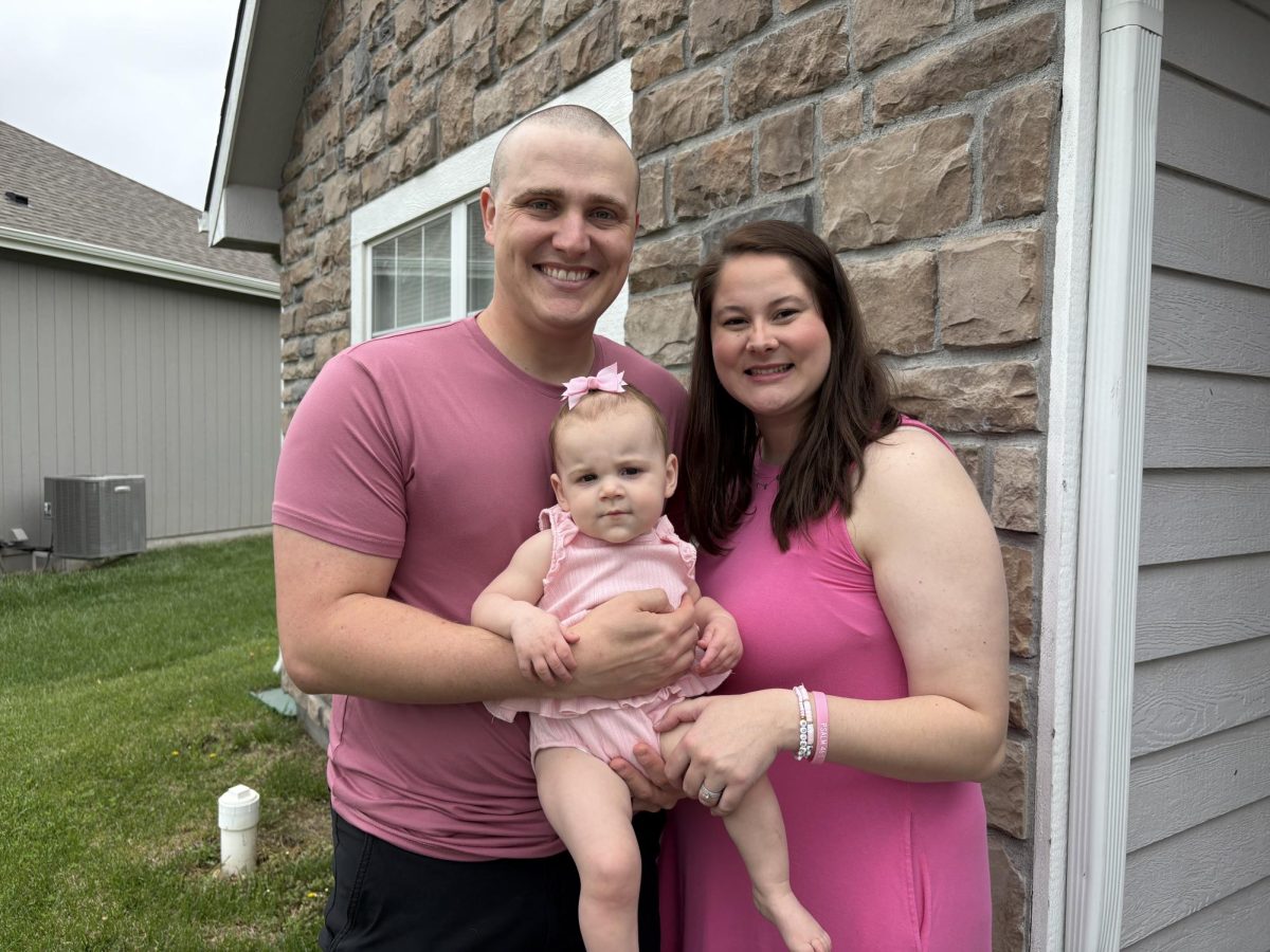 Eric and Kennedy Yoxall and their daughter Mabel wear pink in recognition of breast cancer awareness. Kennedy just went through her first round of chemo. 