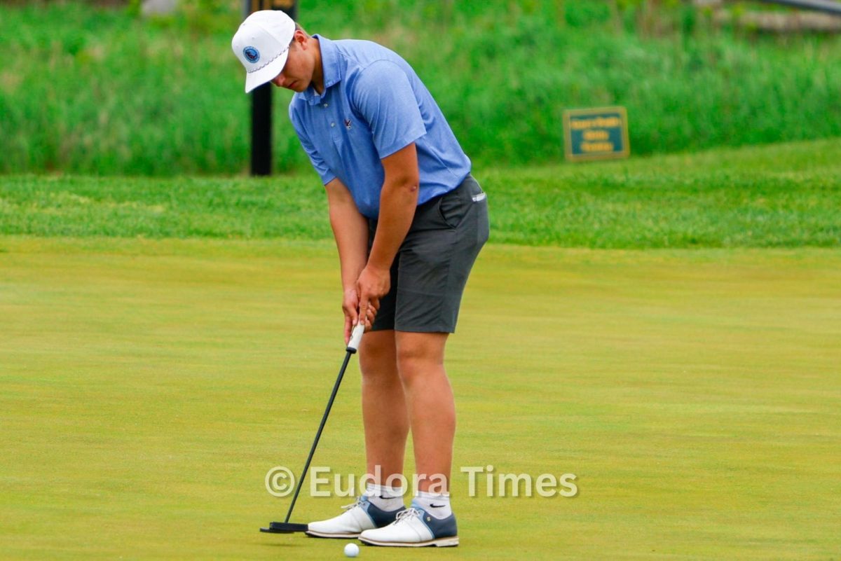 Junior Brady Von Holten lines up for a putt. Von Holten is playing on the golf and track and field teams this spring. 
