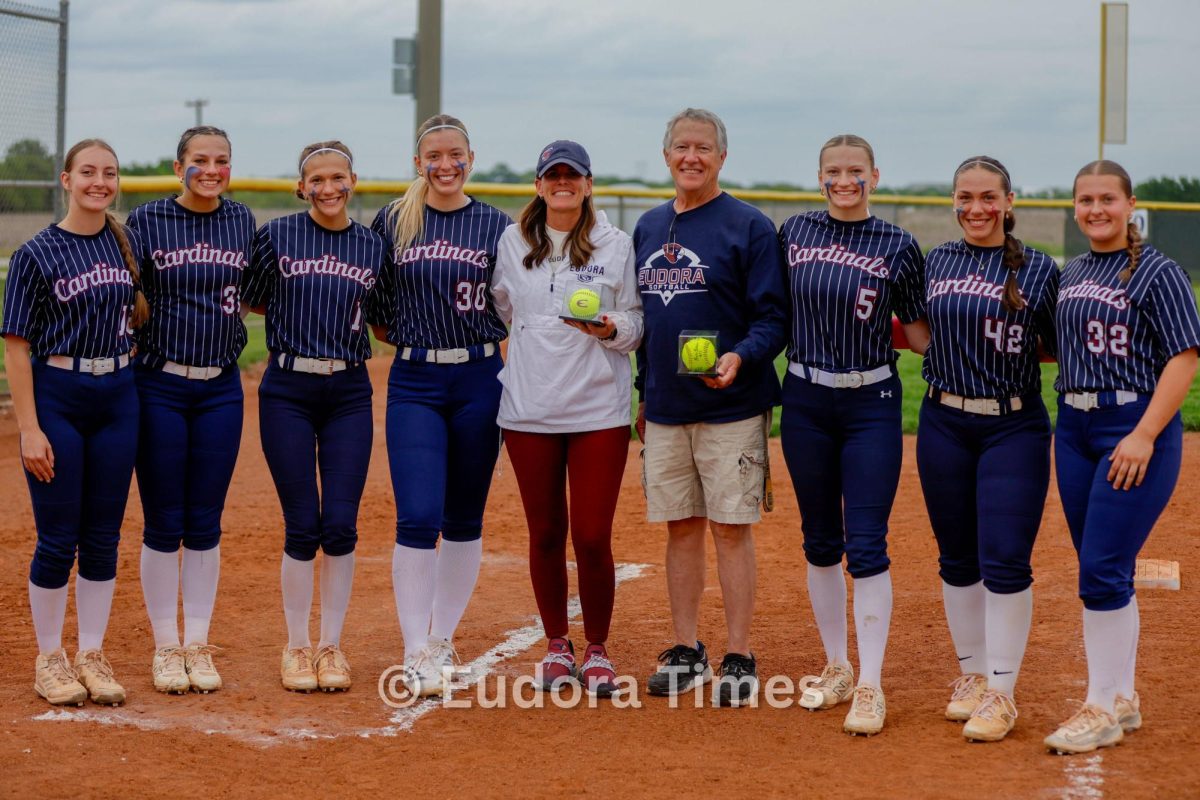The softball seniors pose with their coaches during Tuesday’s senior night recognition.

