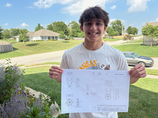 Colton Jenkins holds his Wheel Assembly project from the state competition that he won in April. Jenkins said at the state competition, he was given a poorly made drawing and had to correct it. His adviser, Scott Lickteig, said Jenkins’ drawing was 95% accurate. Jenkins is also wearing his Kansas shirt given to him by SkillsUSA. All delegates had to wear their state shirt on the first day of the national competition.