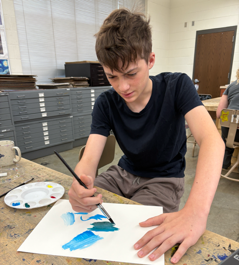 Ethan Dietz experiments with the wash art technique as he works on his project. He is creating a cover for “The Twyford Code” and said he has never used wash before.