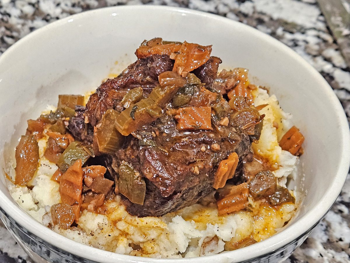 Braised short ribs are seared to perfection before being slow cooked in the oven with lots of vegetables and seasonings, along with wine and beef stock, to create a rich sauce. 