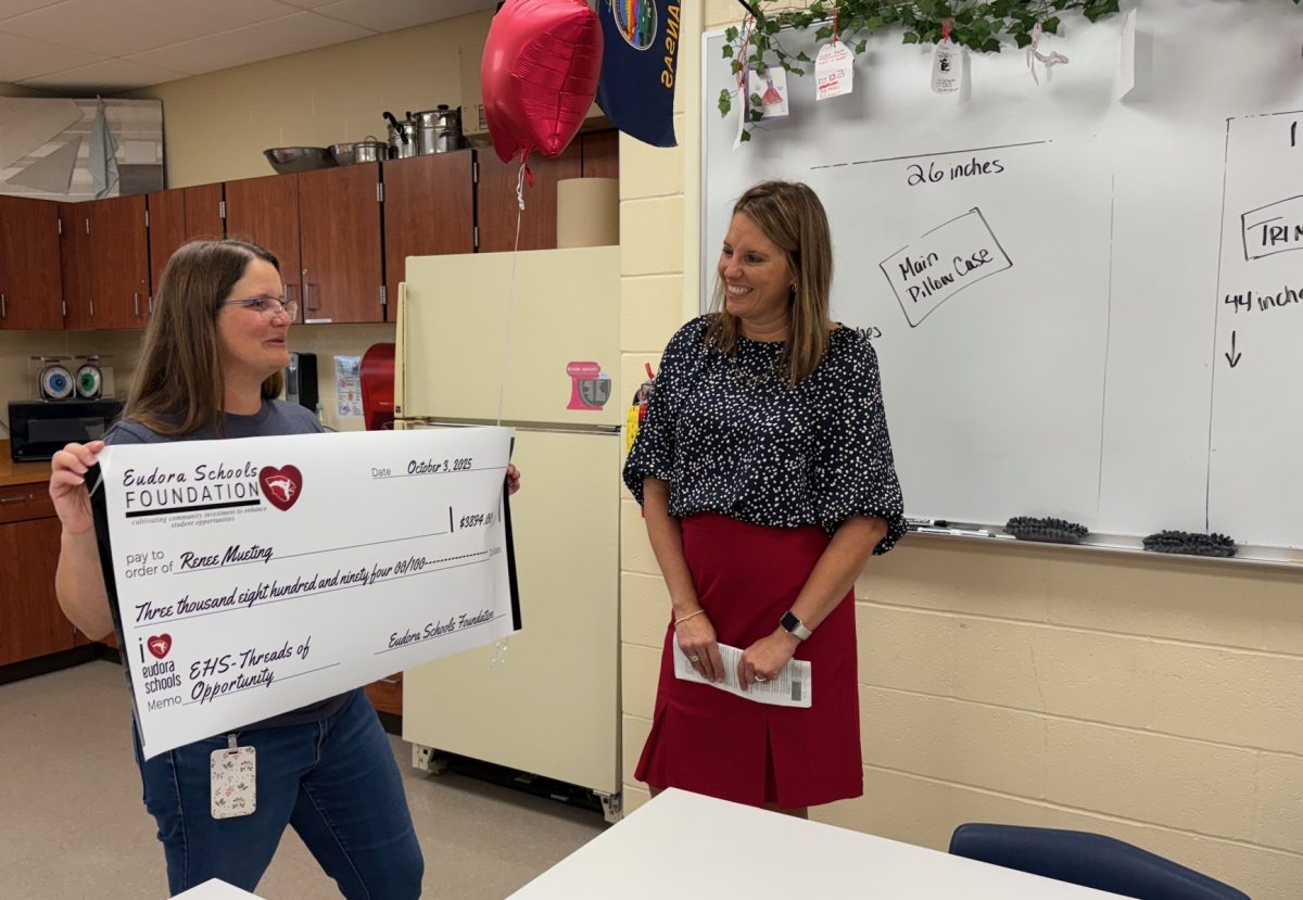 Shanda Hurla smiles as Renee Mueting discusses how she will use her $3,894 grant.
